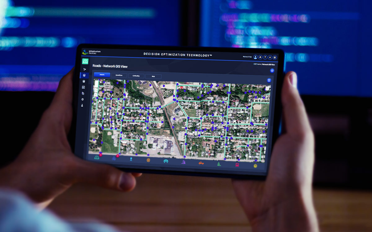 Engineer viewing decision optimization technology software GIS interface in night-mode on the tablet device